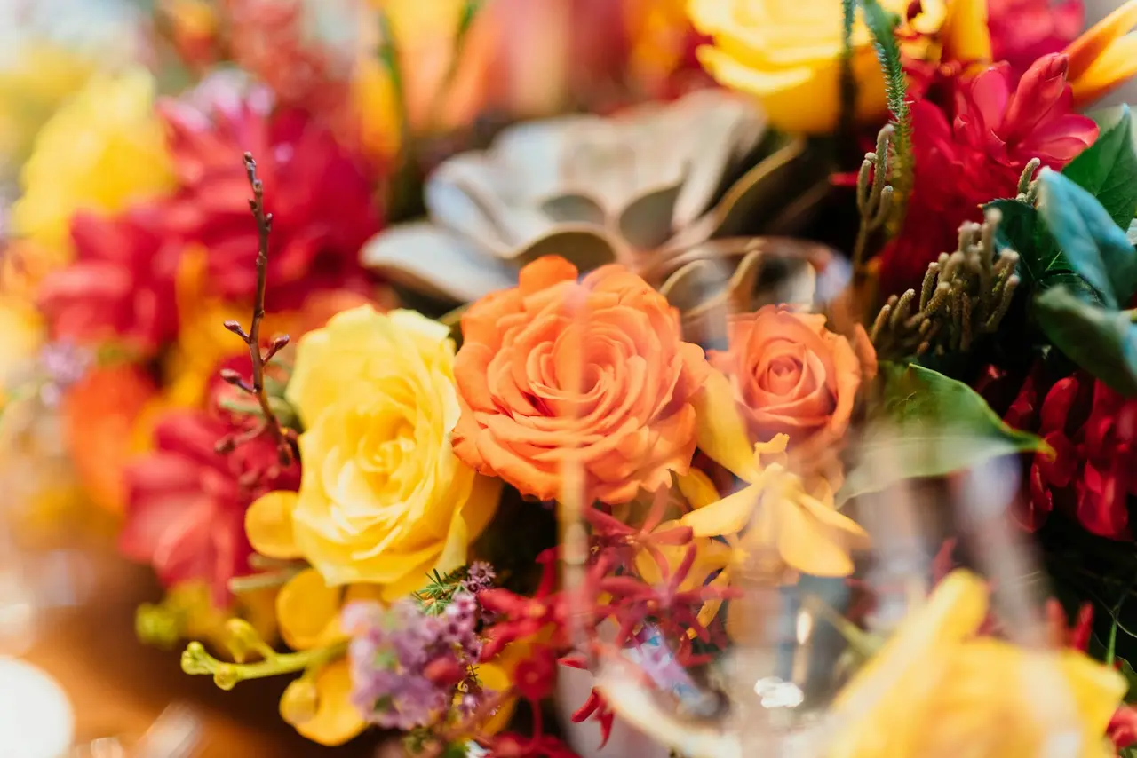 A bouquet of roses, dahlias, and orchids